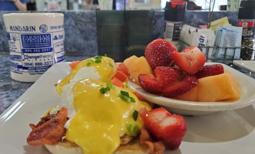 Close up of Eggs on the Bayou with a side of mixed fruit at Beach Diner at Atlantic Beach served at the counter